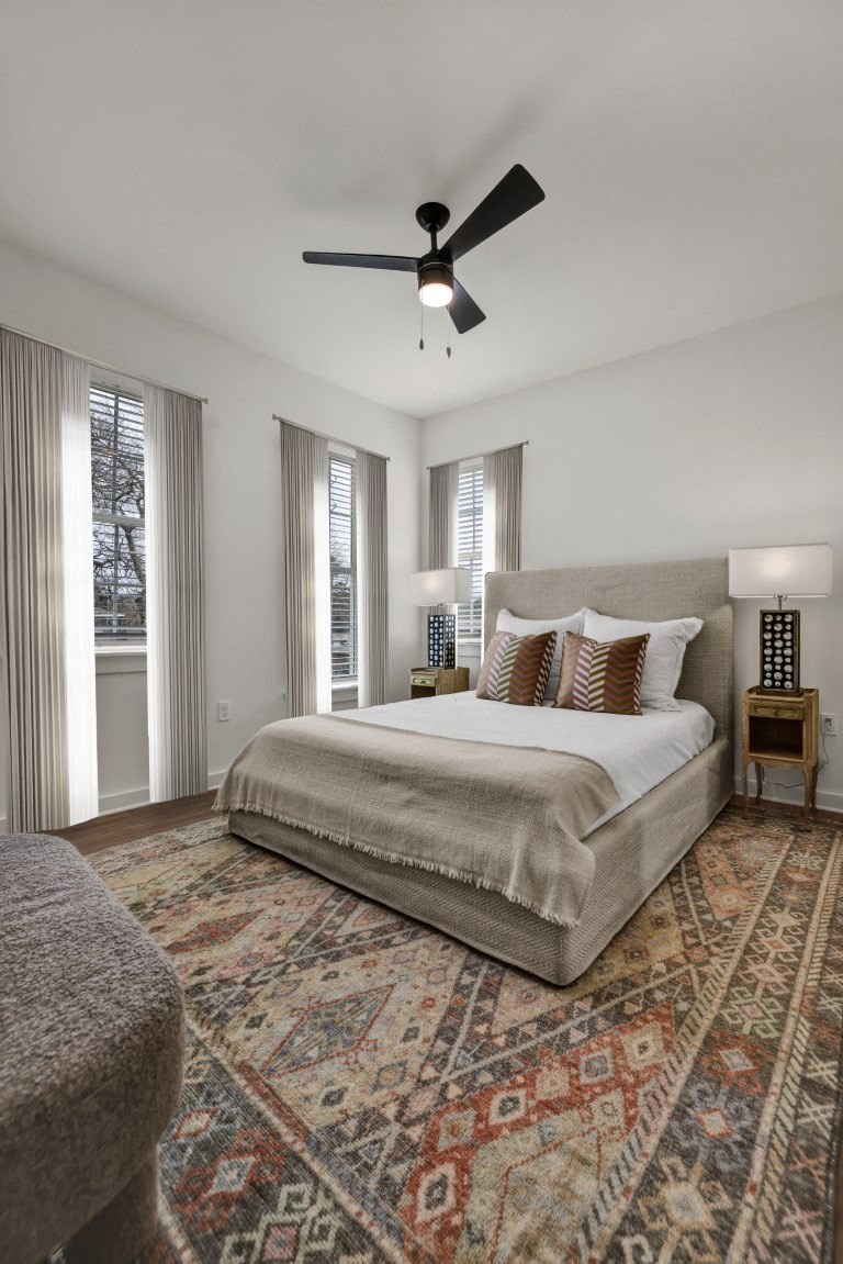 Bedroom with ceiling fan and wood-style flooring at West Row Townhomes and Apartments in Birmingham, AL
